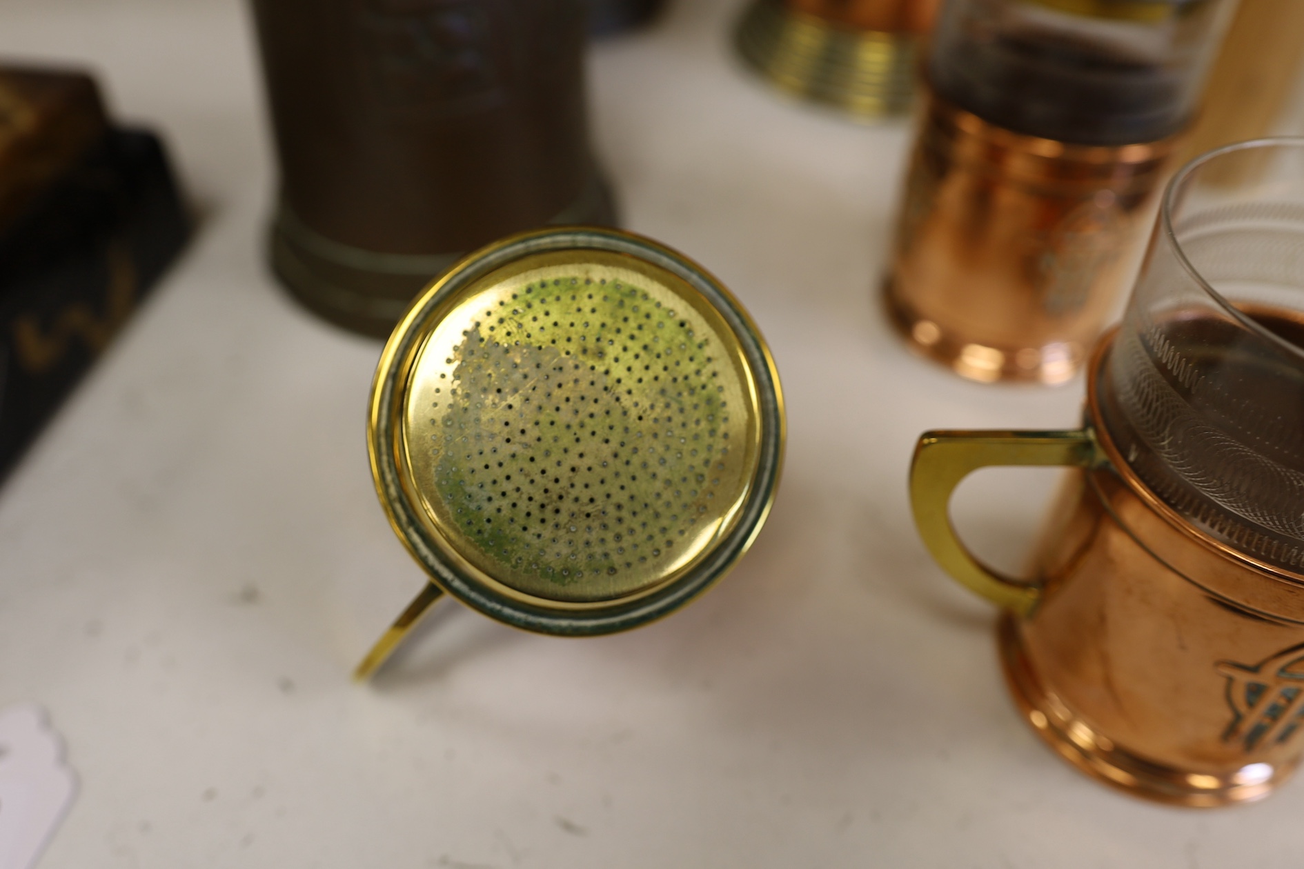 Three Art Nouveau mixed copper and brass coffee pots and two individual copper filter coffee glasses, tallest 36cm high (5). Condition - two pots need cleaning, but good condition for age